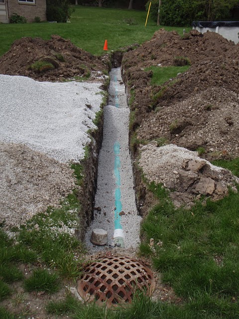 To meet code Bob's Grading always installs at least 4" of stone beneath the pipe and 12" on top. - Bob's Grading Milwaukee